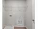 An efficient laundry room featuring hookups, a wire shelf, and neutral walls at 344 Riverwood Pass, Dallas, GA 30157