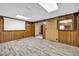 Bright basement area with wood paneling, vinyl flooring, and kitchenette at 3734 N Camp Creek Sw Pkwy, Atlanta, GA 30331