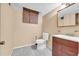 Small basement bathroom with toilet, sink, and vanity at 3734 N Camp Creek Sw Pkwy, Atlanta, GA 30331