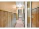 Long hallway with wood paneling and carpeted flooring at 3734 N Camp Creek Sw Pkwy, Atlanta, GA 30331