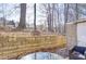 Small patio with retaining wall, storage shed, and wooded area at 6414 Wedgewood Trce, Tucker, GA 30084