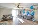 Living room with hardwood floors, ceiling fan, and sliding glass doors at 6414 Wedgewood Trce, Tucker, GA 30084