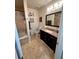 Bathroom includes a tub, granite vanity, and tile flooring at 200 Renaissance Ne Pkwy # 305, Atlanta, GA 30308