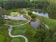 Aerial view of serene golf course with water features and lush greens at 4844 Elkhorn Hill Dr, Suwanee, GA 30024