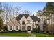 Stunning brick and stone two-story home with a large front yard at 4844 Elkhorn Hill Dr, Suwanee, GA 30024