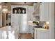 White kitchen with marble countertops and ample storage at 4844 Elkhorn Hill Dr, Suwanee, GA 30024