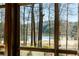 Scenic view of a lake from inside the home through a multi-paned window at 4844 Elkhorn Hill Dr, Suwanee, GA 30024