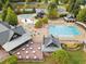 Aerial view of community pool, clubhouse, and surrounding landscaping at 4844 Elkhorn Hill Dr, Suwanee, GA 30024