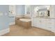 Luxurious bathroom featuring a soaking tub and white vanities at 5288 East Cherokee Dr, Canton, GA 30115