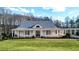 White farmhouse with gray metal roof, large windows, and a spacious lawn at 5288 East Cherokee Dr, Canton, GA 30115