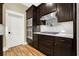 Modern kitchen with dark cabinetry, stainless steel appliances, and subway tile backsplash at 5288 East Cherokee Dr, Canton, GA 30115