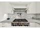 Modern gas cooktop with marble backsplash and pot filler at 5288 East Cherokee Dr, Canton, GA 30115