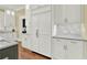 White kitchen cabinets and countertops with stainless steel appliances at 5288 East Cherokee Dr, Canton, GA 30115