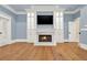 Elegant living room featuring hardwood floors and a cozy fireplace at 5288 East Cherokee Dr, Canton, GA 30115