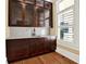 Built-in wet bar with glass-front cabinets and quartz countertop at 5288 East Cherokee Dr, Canton, GA 30115