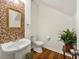 Powder room with pedestal sink and mosaic tile accent wall at 1503 Dolcetto Nw Trce # 2, Kennesaw, GA 30152