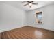 Simple bedroom with wood floors and large window at 8951 Country Club Dr, Douglasville, GA 30134