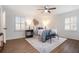 Bright bedroom with wood floors, ceiling fan, and plantation shutters at 8951 Country Club Dr, Douglasville, GA 30134