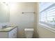 Small bathroom with granite countertop vanity, toilet, and window at 2833 Lynda Pl, Decatur, GA 30032