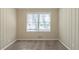 Bright bedroom with neutral walls and carpet, featuring a large window and ample closet space at 2833 Lynda Pl, Decatur, GA 30032