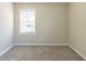 Simple bedroom with neutral walls and carpet, featuring a window with blinds at 2833 Lynda Pl, Decatur, GA 30032