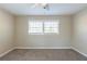 Spacious bedroom with neutral walls, carpet, ceiling fan, and large window at 2833 Lynda Pl, Decatur, GA 30032