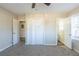 Large bedroom with neutral walls and carpet, featuring a double door closet and en-suite bathroom at 2833 Lynda Pl, Decatur, GA 30032