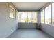 Bright screened porch with painted brick walls and concrete flooring at 2833 Lynda Pl, Decatur, GA 30032