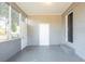 Enclosed porch with painted brick, concrete flooring, storage closet, and exterior door at 2833 Lynda Pl, Decatur, GA 30032