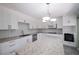 Modern kitchen with white cabinets, granite island, and stainless steel appliances at 4617 Dunover Cir, Dunwoody, GA 30360