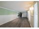 Spacious living room featuring hardwood floors, light green walls, and white wainscoting at 4617 Dunover Cir, Dunwoody, GA 30360