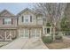 Two-story townhome with stone accents and a two-car garage at 1600 Watercress Se Ct, Mableton, GA 30126