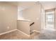 Upstairs hallway with neutral colored walls and carpet flooring at 1600 Watercress Se Ct, Mableton, GA 30126