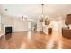 Open concept living space with hardwood floors, kitchen island, and fireplace at 1600 Watercress Se Ct, Mableton, GA 30126