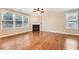 Hardwood floor living room with fireplace and ceiling fan at 1600 Watercress Se Ct, Mableton, GA 30126
