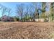 Large backyard with leaf covered ground and wooden fence at 4312 Pleasant Forest Dr, Decatur, GA 30034