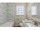 Updated bathroom with granite vanity and marble tile at 4312 Pleasant Forest Dr, Decatur, GA 30034