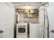 Bright laundry room with washer, dryer, and ample shelving at 1365 Sanden Ferry Dr, Decatur, GA 30033