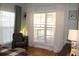Bedroom with an armchair and large window with curtains at 162 Gainesborough Dr, Dallas, GA 30157