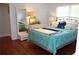 Bedroom with full bed, hardwood floors, and large mirror at 162 Gainesborough Dr, Dallas, GA 30157