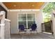 Covered deck with two chairs and wood ceiling at 162 Gainesborough Dr, Dallas, GA 30157