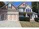 Two-story house with brick and siding, three-car garage, and well-maintained landscaping at 162 Gainesborough Dr, Dallas, GA 30157