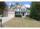 Two-story house with brick and siding, three-car garage, and landscaped yard at 162 Gainesborough Dr, Dallas, GA 30157