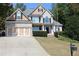 Brick and siding two-story house, three-car garage, and manicured lawn at 162 Gainesborough Dr, Dallas, GA 30157