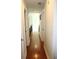 Long hallway with hardwood floors and access to bedrooms at 162 Gainesborough Dr, Dallas, GA 30157