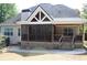 Back of house showing screened porch, deck, and landscaping at 162 Gainesborough Dr, Dallas, GA 30157