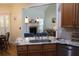 Kitchen island with granite countertop, farmhouse sink, and view into Gathering room at 162 Gainesborough Dr, Dallas, GA 30157