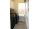 Laundry room with washer, dryer, and built-in shelving at 162 Gainesborough Dr, Dallas, GA 30157