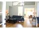 Open living room with hardwood floors, a comfortable sofa, and views to the dining area at 162 Gainesborough Dr, Dallas, GA 30157