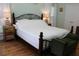 Main bedroom with king-size bed, hardwood floors, and ample natural light at 162 Gainesborough Dr, Dallas, GA 30157